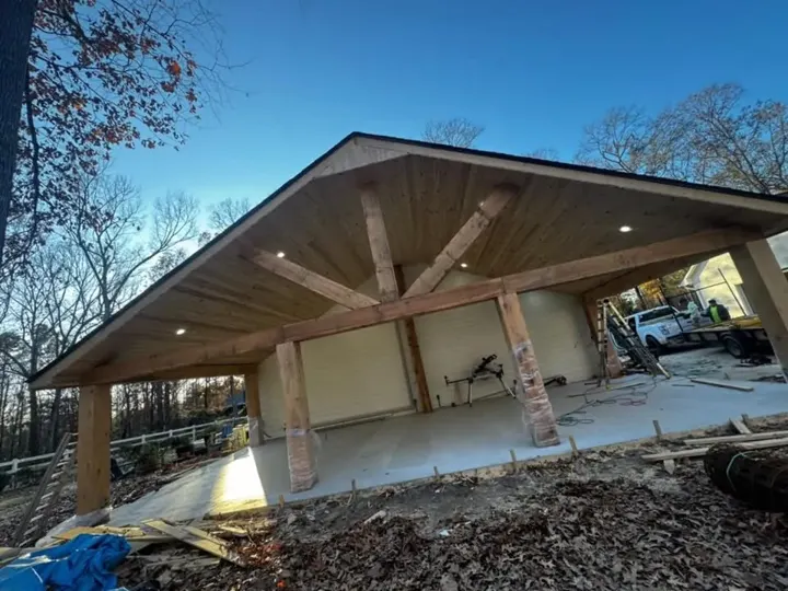 Timber pavilion frame over a fresh concrete slab